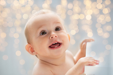 Image showing happy little baby boy or girl looking up