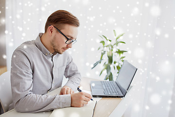 Image showing creative man or businessman writing to notebook