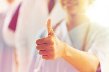 Image showing close up of doctor or nurse showing thumbs 