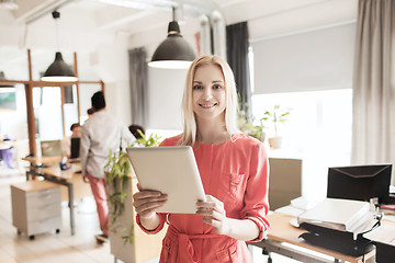 Image showing happy creative female office worker with tablet pc