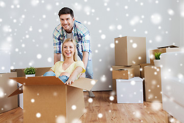 Image showing happy couple having fun with boxes at new home