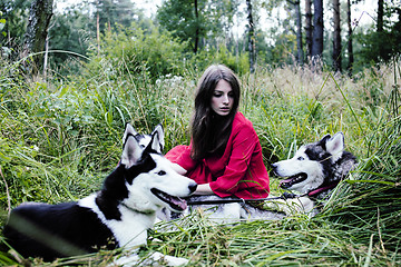 Image showing woman in red dress with tree wolfs, forest, husky dogs mystery p