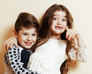 Image showing little cute boy and girl hugging playing on white background, ha