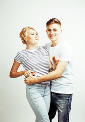 Image showing young pretty teenage couple, hipster guy with his girlfriend happy smiling and hugging isolated on white background, lifestyle people concept