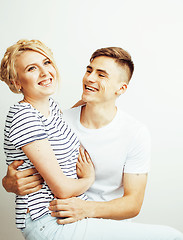 Image showing young pretty teenage couple, hipster guy with his girlfriend happy smiling and hugging isolated on white background, lifestyle people concept