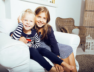 Image showing two cute sisters at home interior playing, little happy smiling 