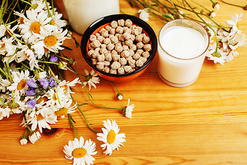 Image showing Simply stylish wooden kitchen with bottle of milk and glass on t