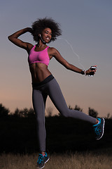 Image showing black woman is doing stretching exercise relaxing and warm up