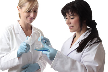 Image showing Scientists with test tube, bottle and petri dish