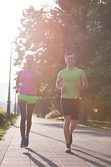 Image showing young multiethnic couple jogging in the city