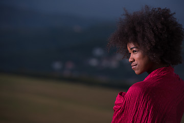 Image showing outdoor portrait of a black woman with a scarf