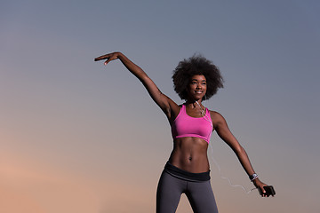 Image showing black woman is doing stretching exercise relaxing and warm up