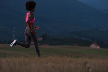 Image showing Young African american woman jogging in nature