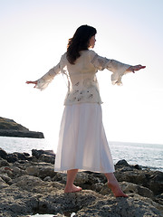 Image showing Young Lady Dancing on Sea Shore