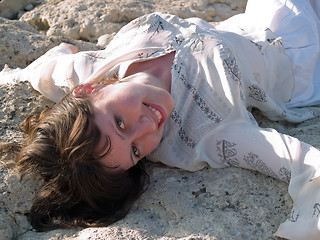 Image showing Portrait of Smiling Lady Ethic Dress Lying on Stone