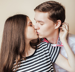 Image showing couple of happy smiling teenagers students, warm colors having a kiss, lifestyle people concept, boy and girl together