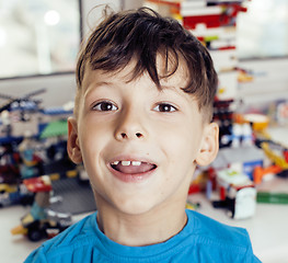 Image showing little cute preschooler boy playing lego toys at home happy smiling, lifestyle children concept