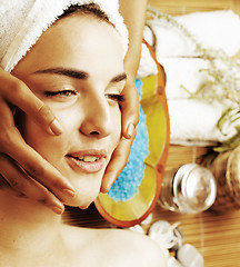 Image showing stock photo attractive lady getting spa treatment in salon, close up asian tan hands on face 