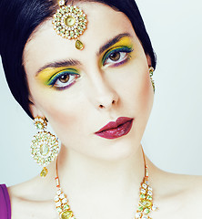 Image showing young pretty caucasian woman like indian in ethnic jewelry close up on white, bridal makeup