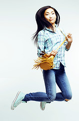 Image showing young pretty jumping asian woman posing cheerful emotional isolated on white background, lifestyle people concept