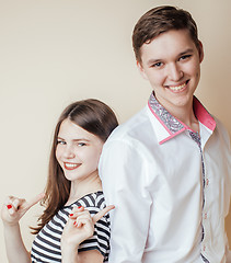 Image showing couple of happy smiling teenagers students, warm colors having a kiss, lifestyle people concept, boy and girl together