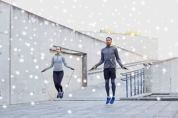 Image showing man and woman exercising with jump-rope outdoors