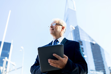 Image showing senior businessman with tablet pc on city street