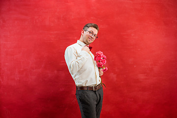 Image showing Young beautiful man with flowers