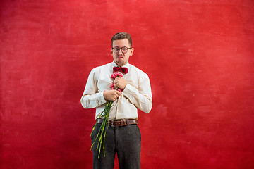 Image showing Young beautiful man with flowers