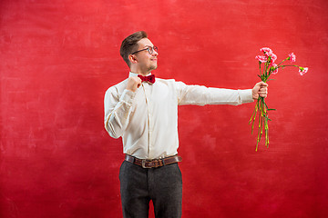 Image showing Young beautiful man with flowers