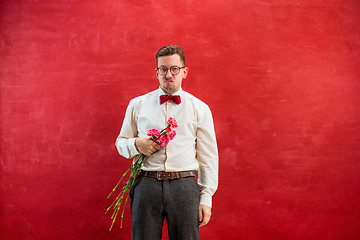Image showing Young beautiful man with flowers