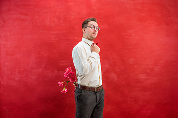 Image showing Man holding bouquet of carnations behind back