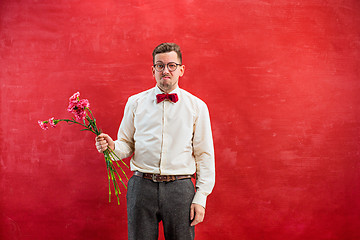 Image showing Young beautiful man with flowers