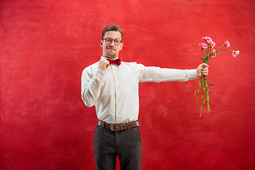 Image showing Young beautiful man with flowers