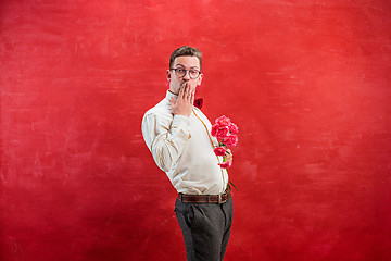 Image showing Young beautiful man with flowers