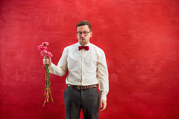 Image showing Young beautiful man with flowers