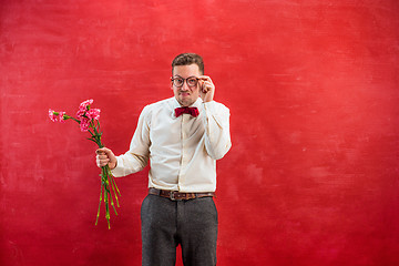 Image showing Young beautiful man with flowers