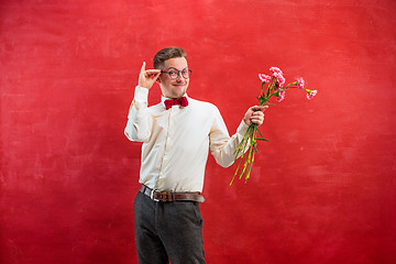 Image showing Young beautiful man with flowers