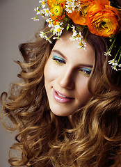 Image showing Beauty young woman with flowers and make up close up, real sprin