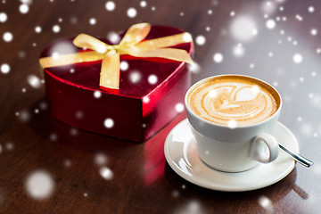 Image showing close up of gift box and coffee cup on table