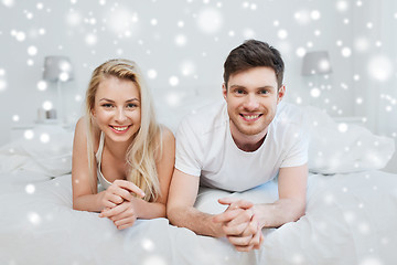 Image showing happy couple lying in bed at home