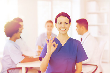 Image showing happy doctor over group of medics at hospital