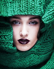 Image showing young pretty woman in sweater and scarf all over her face close 