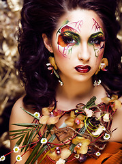 Image showing beauty woman with face art and jewelry from flowers orchids