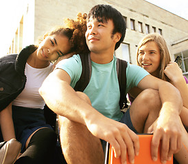 Image showing cute group of teenages at the building of university with books huggings, back to school