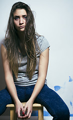 Image showing problem depressioned teenage with messed hair and sad face, junk