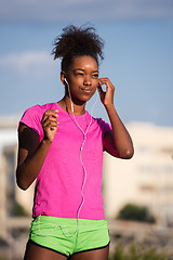 Image showing young african american woman running outdoors