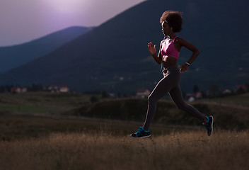 Image showing Young African american woman jogging in nature