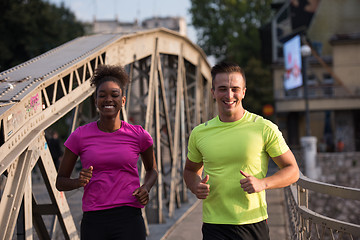 Image showing multiethnic couple jogging in the city