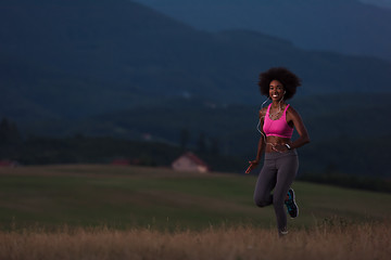 Image showing Young African american woman jogging in nature